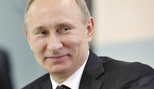 Russian Prime Minister Putin smiles while he visits a school in Russia's Siberian city of Kurgan