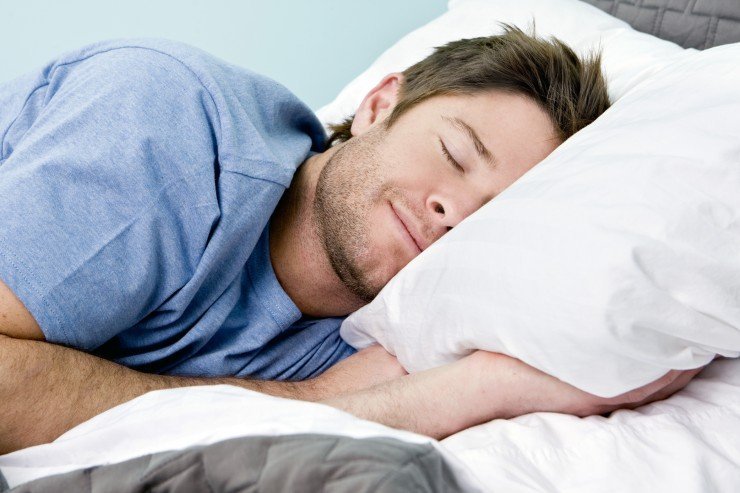 Man comfortably sleeping in his bed