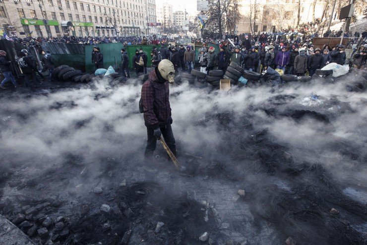 Pro-European integration protesters gather at the site of clashes with riot police in Kiev