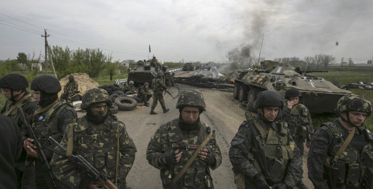 Ukrainian soldiers stand guard at aa Ukranian checkpoint near the eastern town of Slaviansk